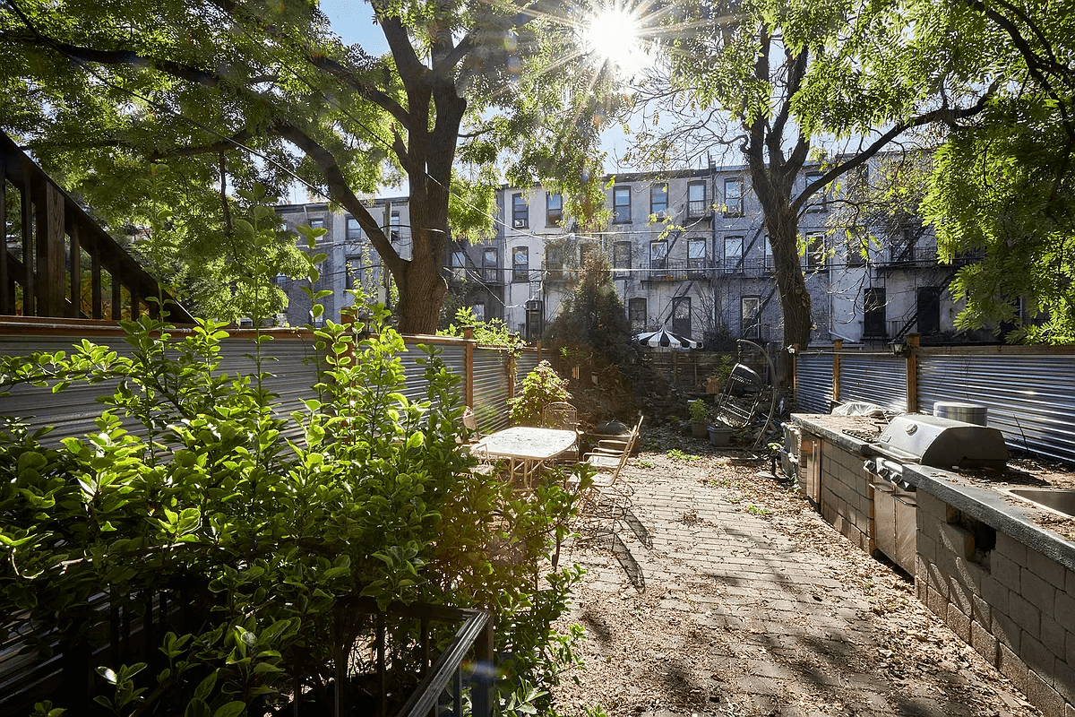 view of the garden with brick paving, a grill and room for dining