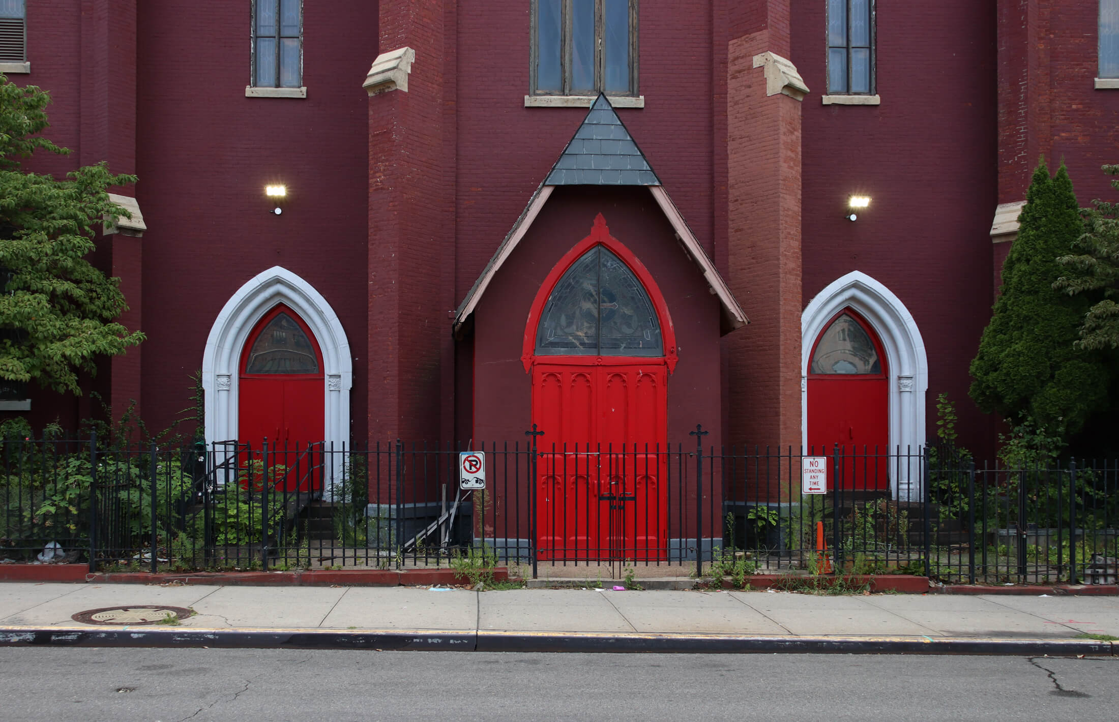 a trio of red doors at the entrance to the church
