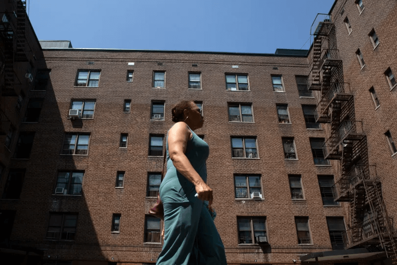 flatbush gardens -person walking by the brick building