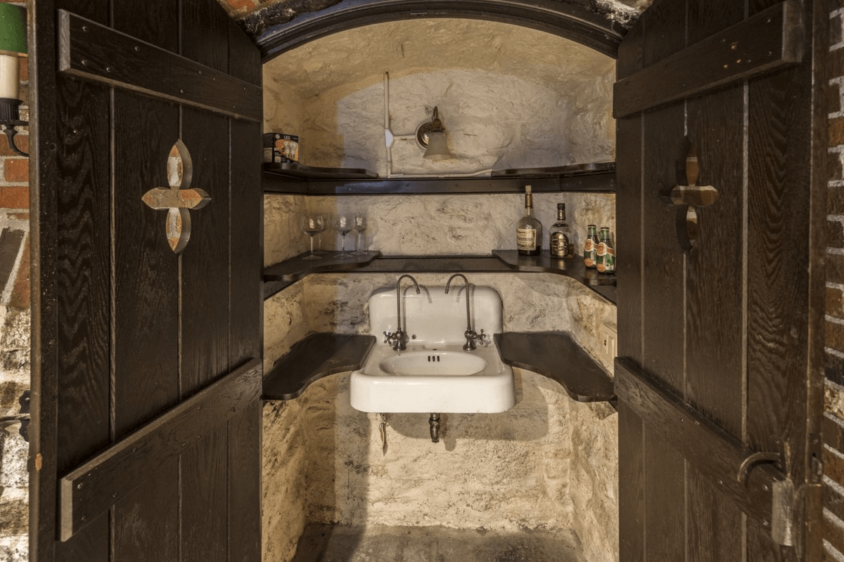 bar with vintage sink behind doors in the basement