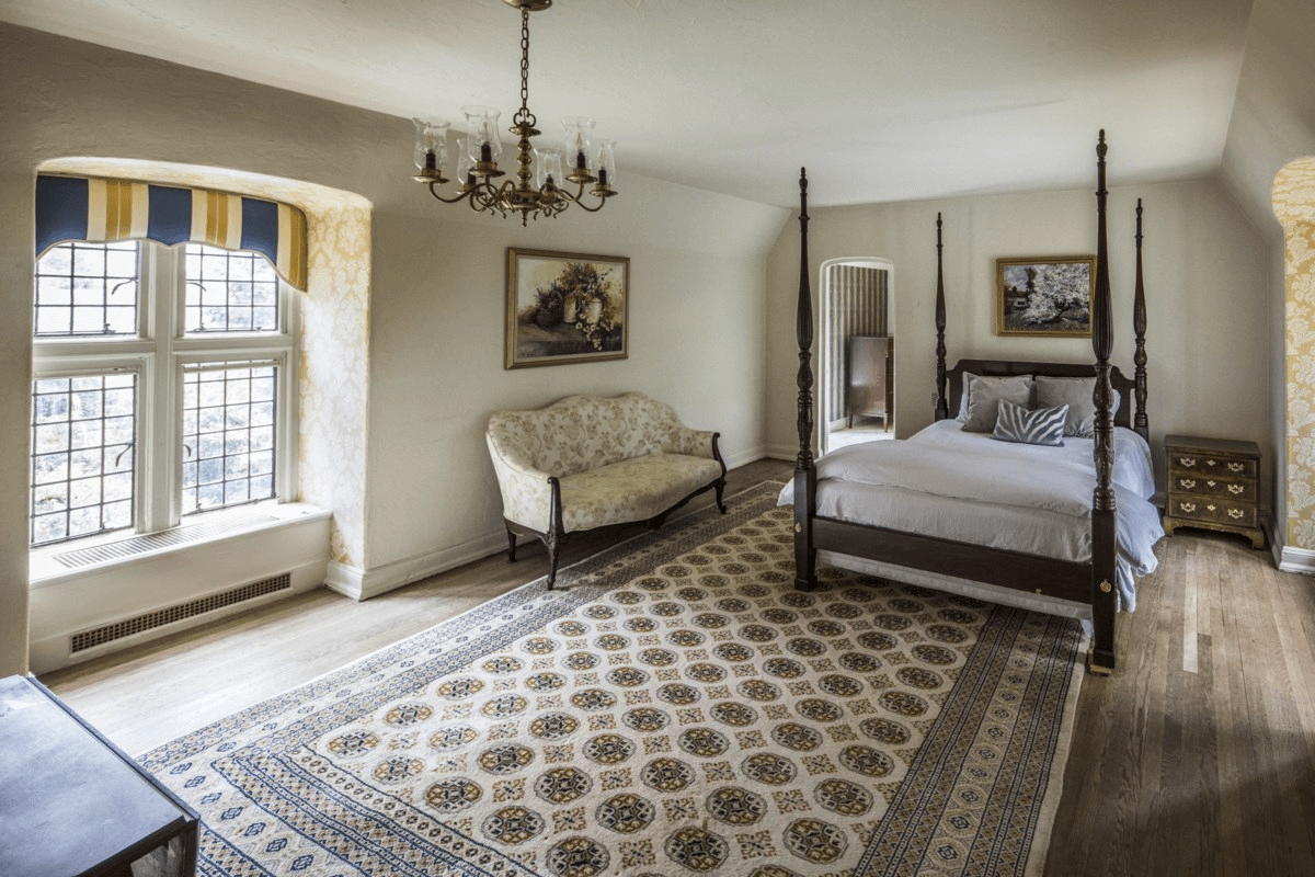 bedroom with wood floors and two exposures