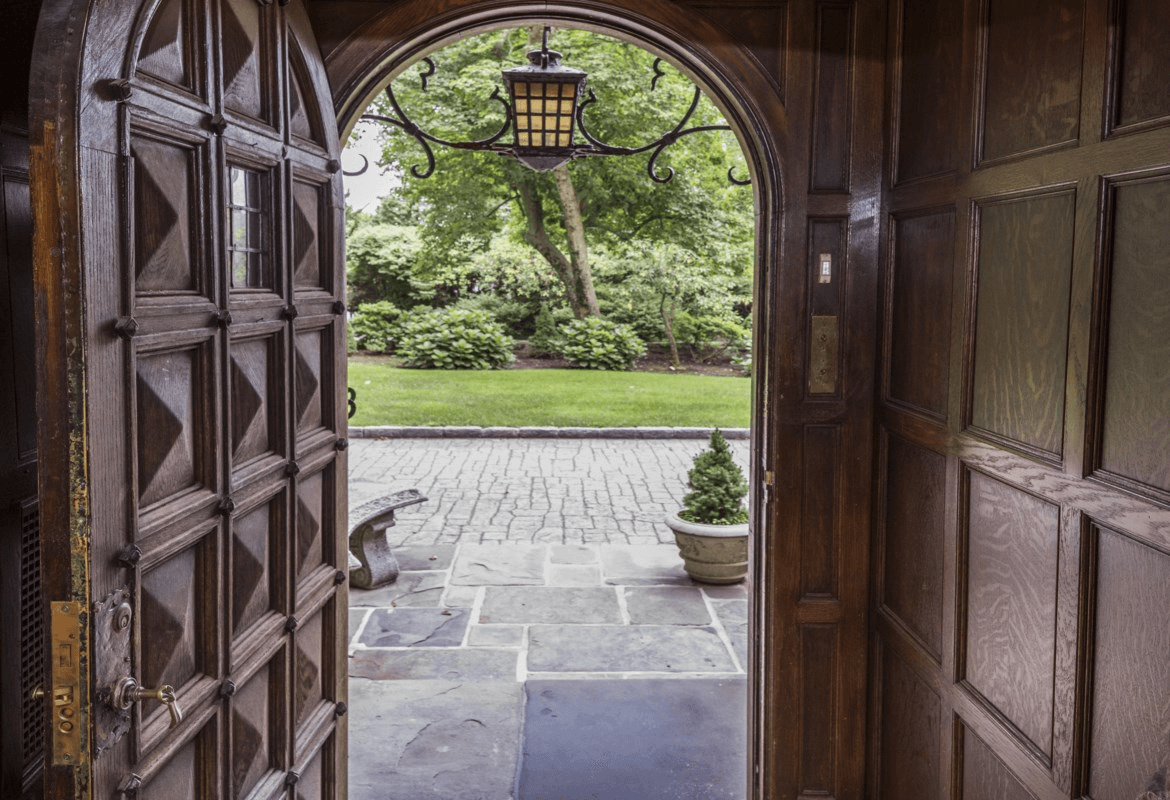 arched entry door with view to drive