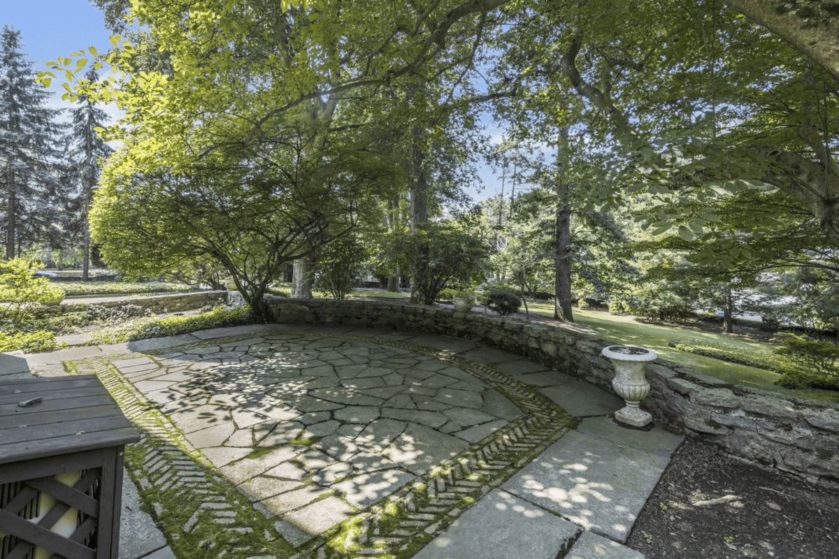 paved patio with a stone wall