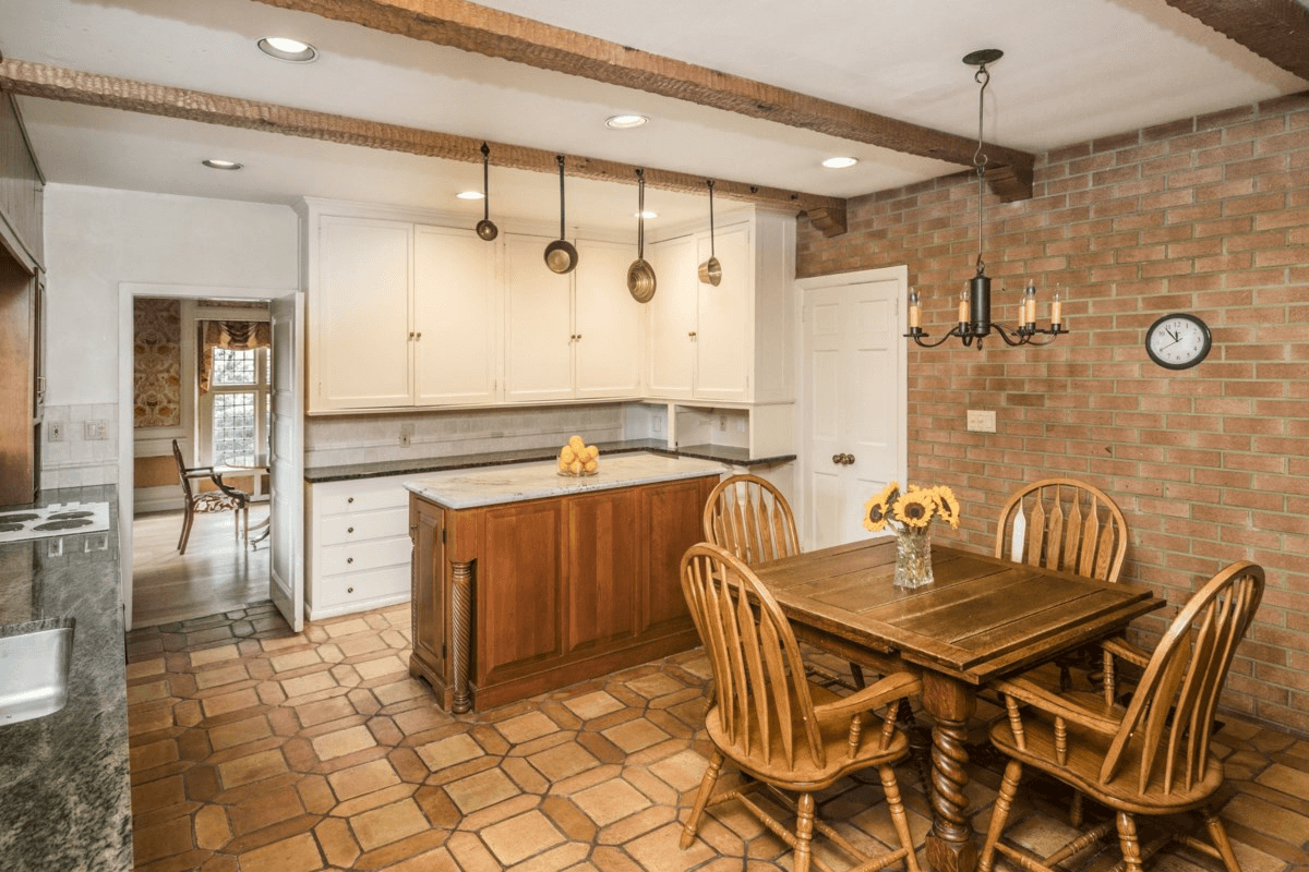 kitchen with wood beams and exposed bricks