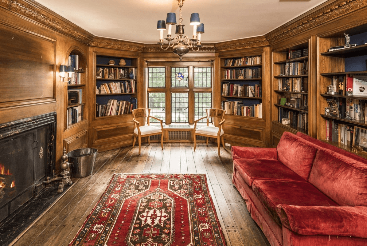 library with built-in shelves and a working fireplace