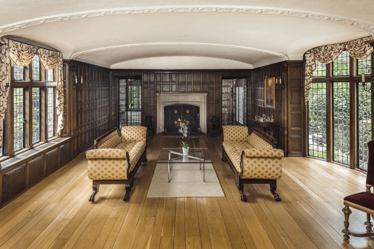 parlor with paneling and fireplace and leaded glass windows