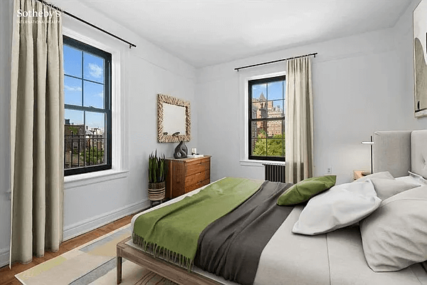 bedroom with two exposures virtually staged with bed