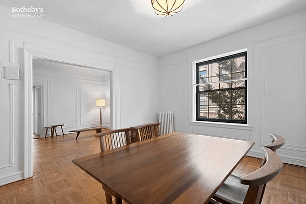 dining room with wall moldings and view into living
