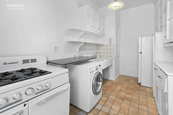 kitchen with tile floor, washer, original cabinets and sink