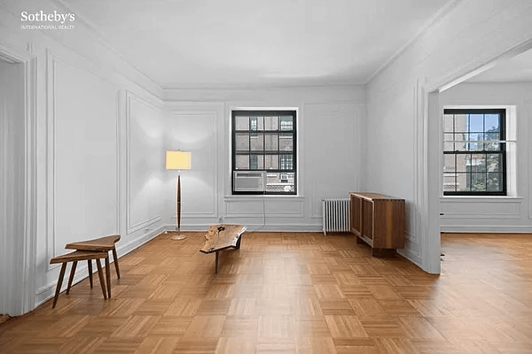 living room with wall moldings, parquet and a doorway to dining room