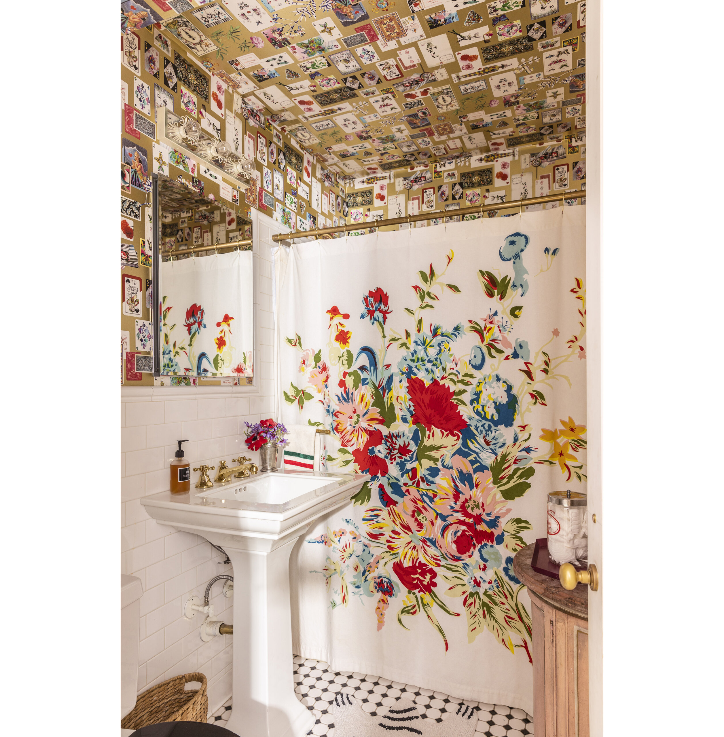 bathroom with wallpaper and a white sink