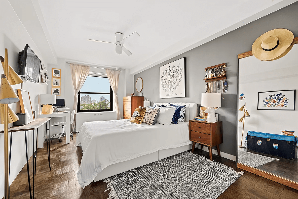 bedroom with ceiling fan and dark parquet floors