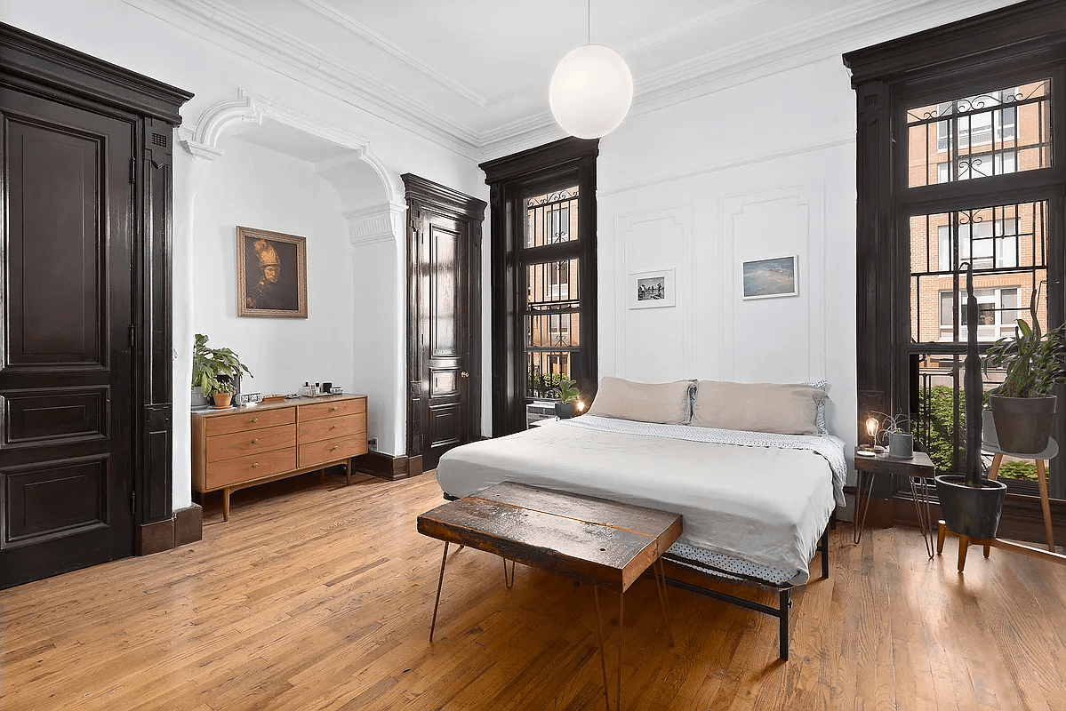 the bedroom with tall windows and a niche