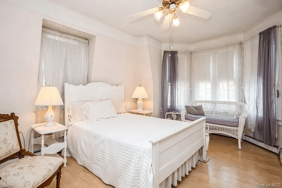 bedroom with ceiling fan and picure rails
