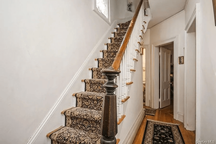 stair with original newel post and view to stair niche