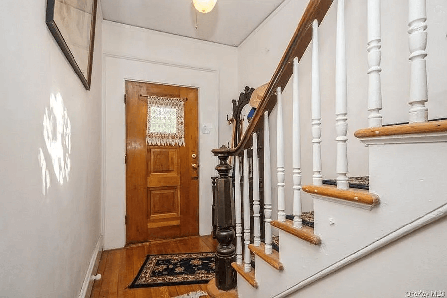 entry way with original stair and newel post