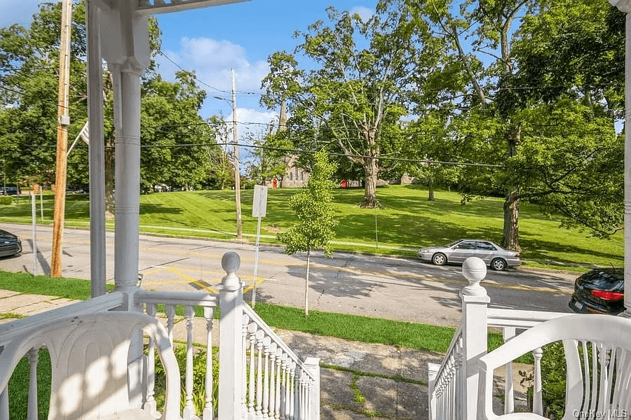 view of open lawn of church across the street