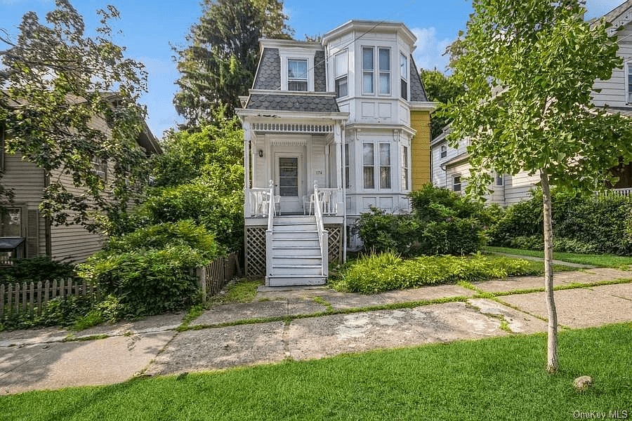 exterior with mansard roof and small front porch