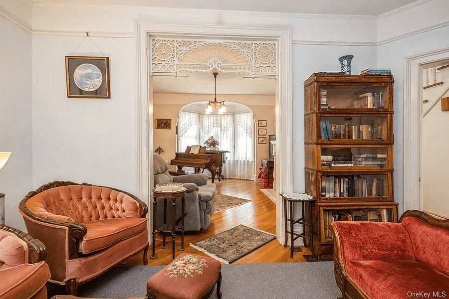 view through doorway with fretwork to front parlor with