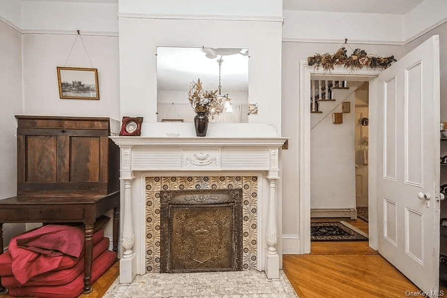 white painted mantel with tile surround