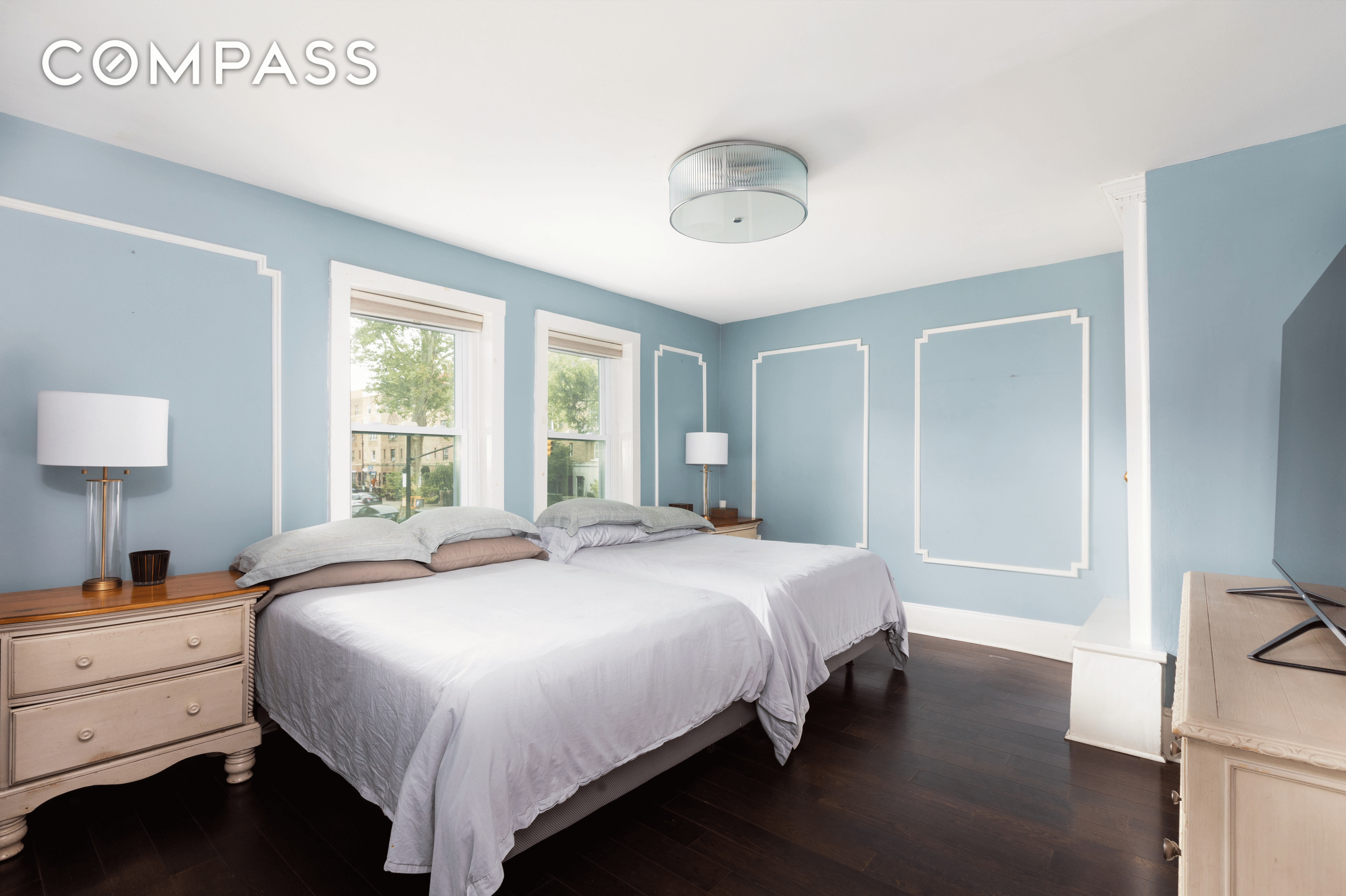 a bedroom with wall moldings and large enough to fit two full beds