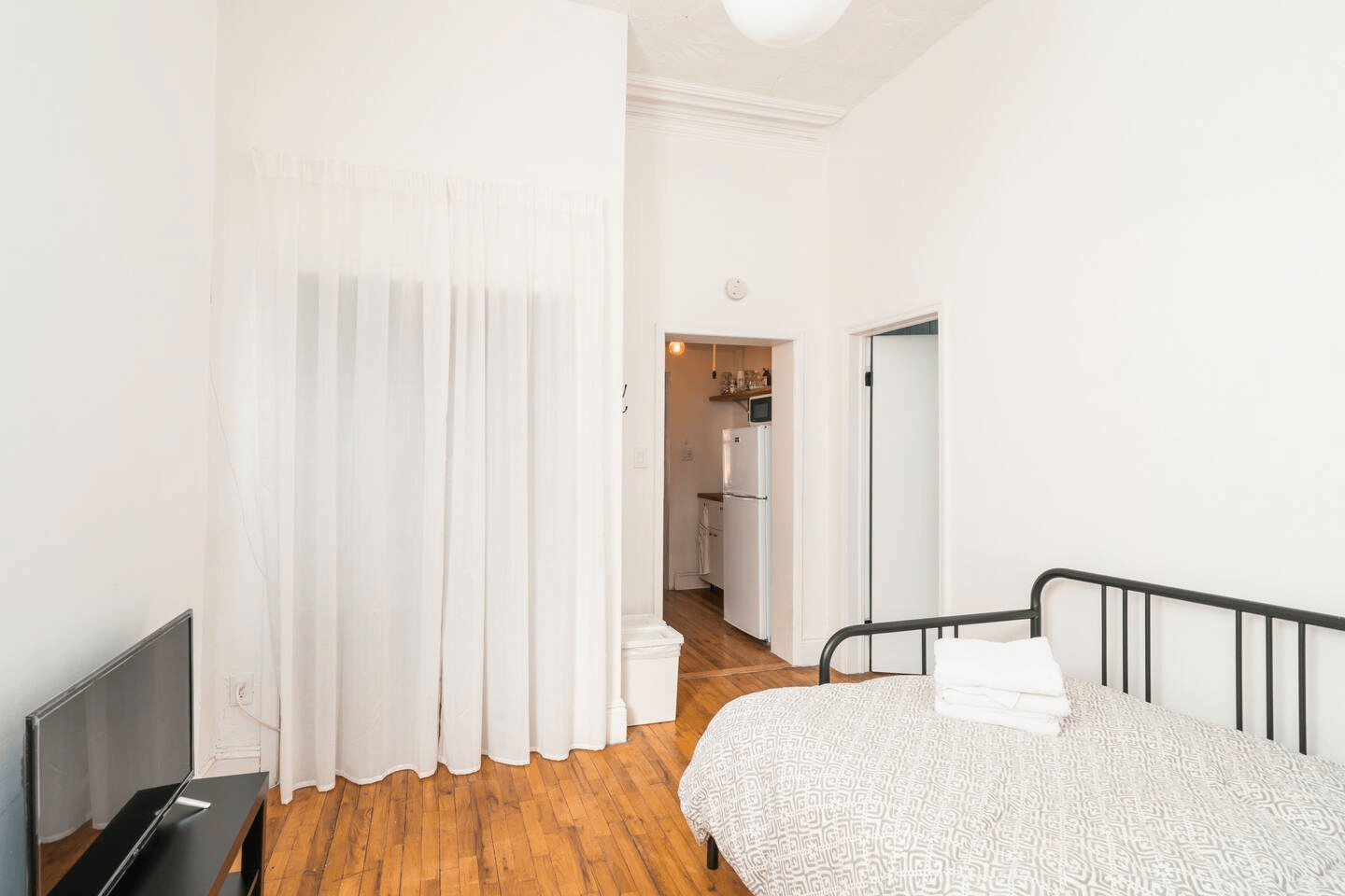 bedroom with a curtain over a closet