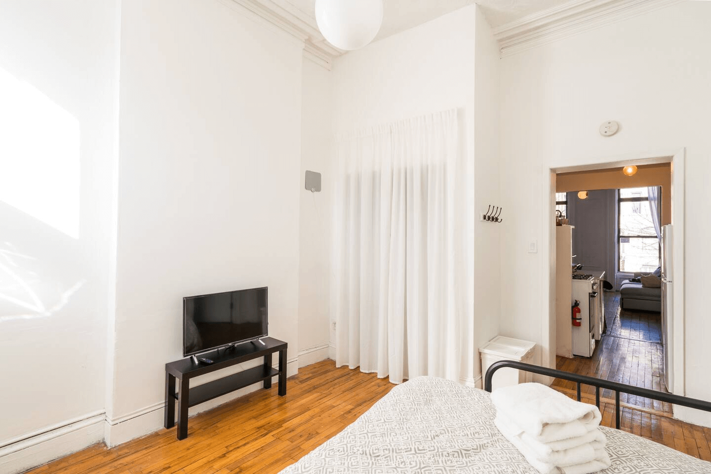 bedroom with open doorway into the kitchen