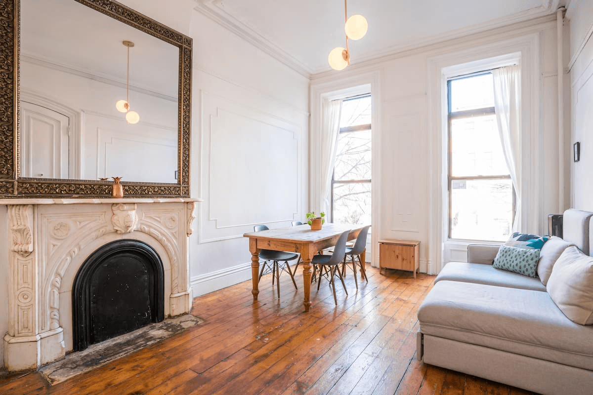 living rom with wall moldings and a marble mantel