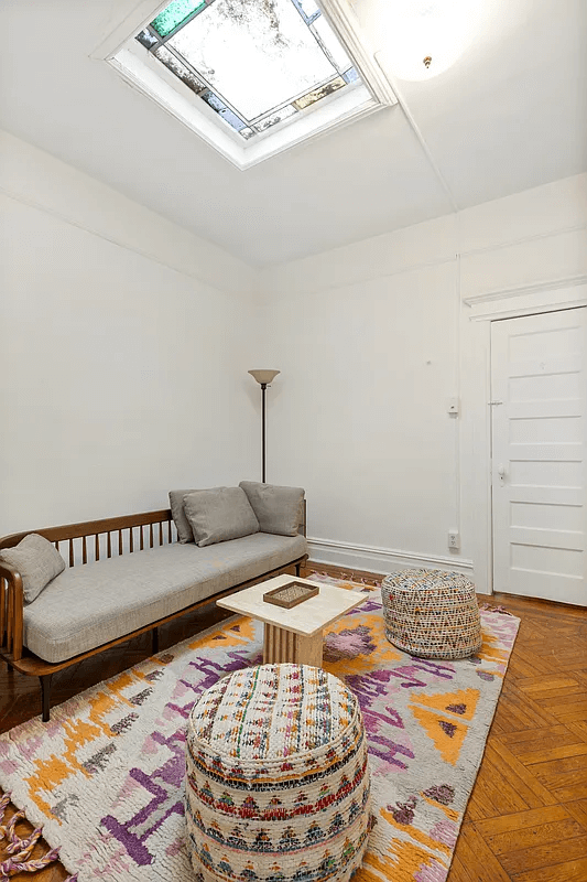 a sitting area with a stained glass skylight