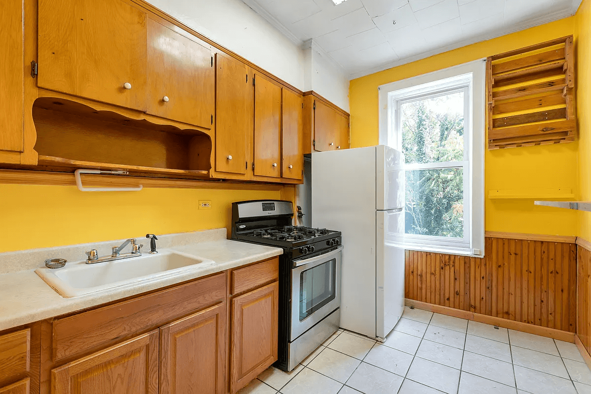 kitchen with a tile floor and upper vintage wood cupboards