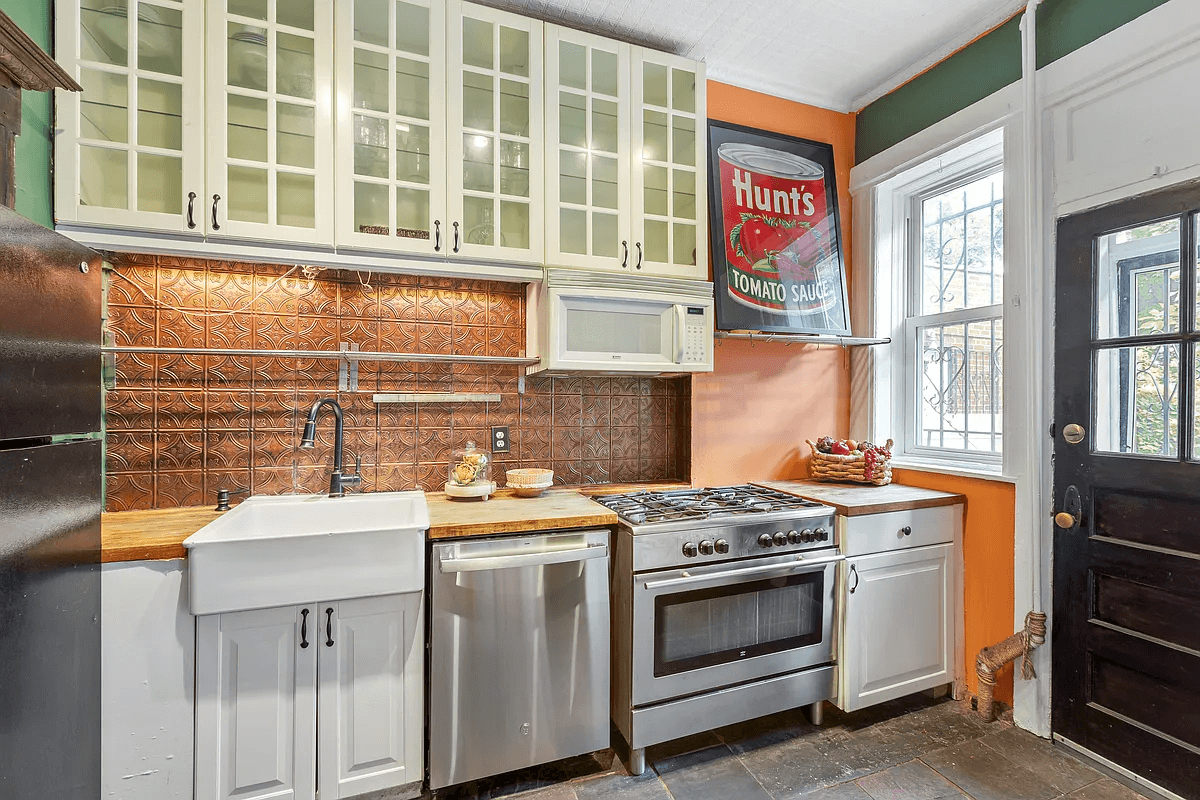 kitchen with apron front sink, white cabinets and door to rear yard