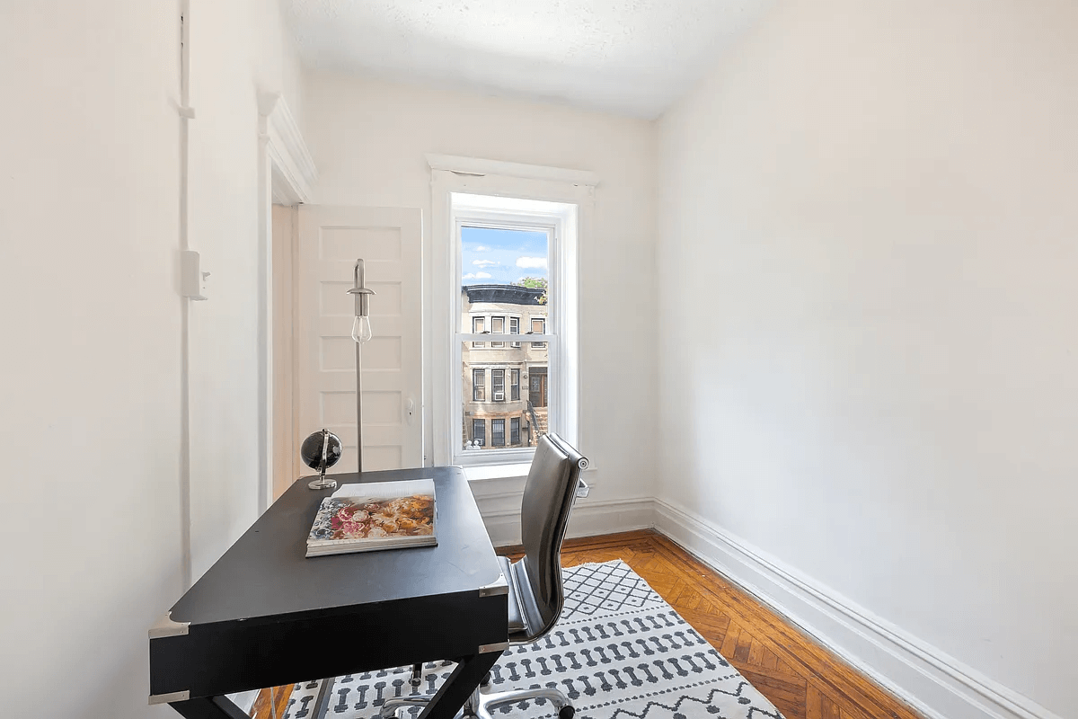 small bedroom with a window set up as an office