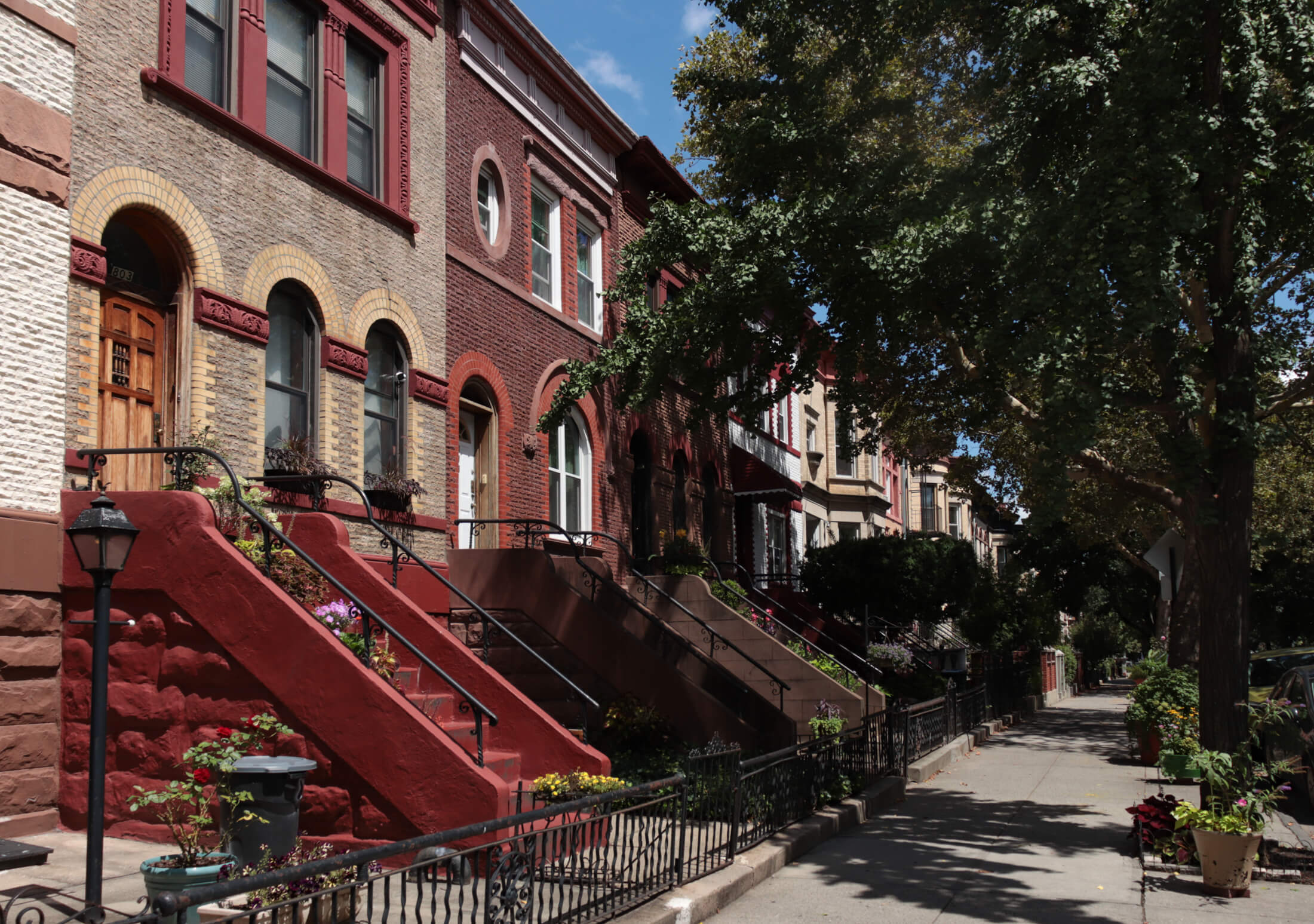 brooklyn-row houses on lincoln place with containers of plants on stoops