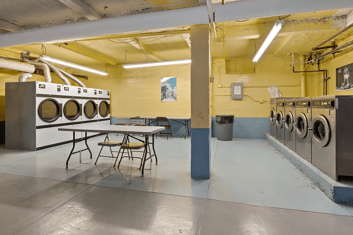 laundry room with five washing machines and four dryers