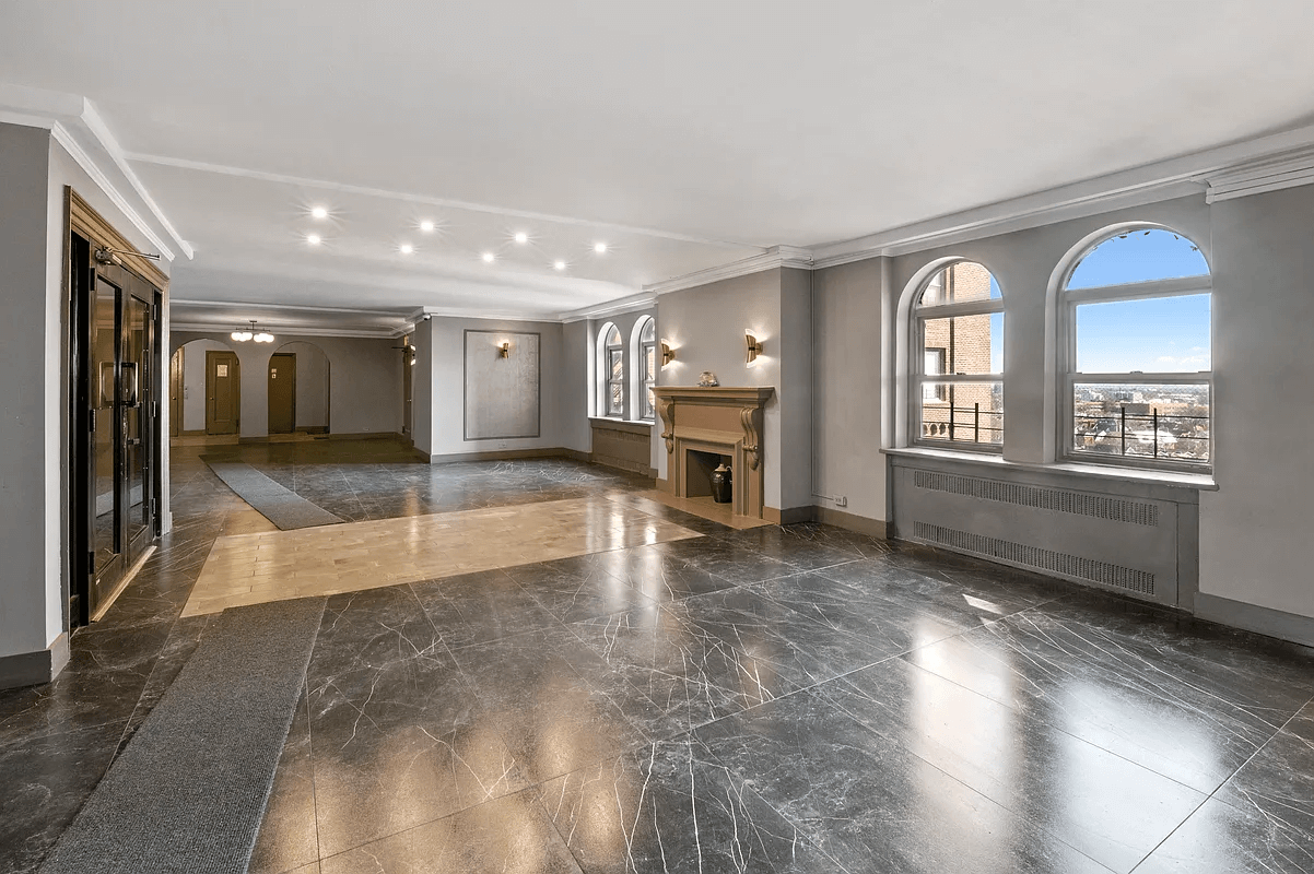 building lobby with dark marble floors and a decorative fireplace