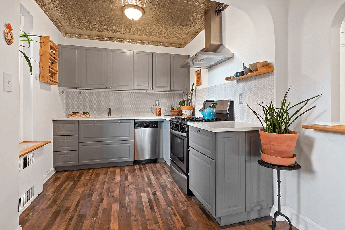 renovated kitchen with tin ceiling and gray cabinets