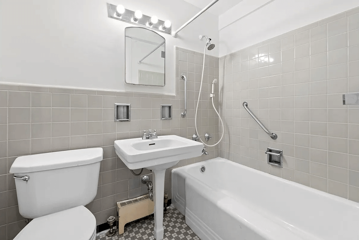 concord village - bathroom with vintage white fixtures and gray wall tile