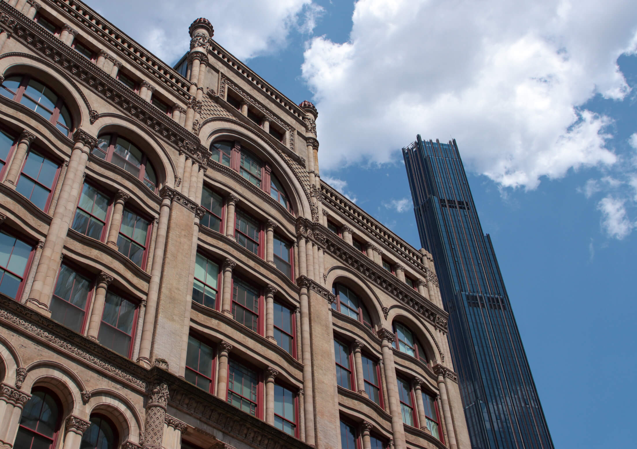 skyline view of the 19th century stone offerman building and the 21st century 9 dekalb tower