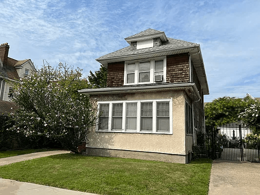 shingle and stucco exterior of the detached home