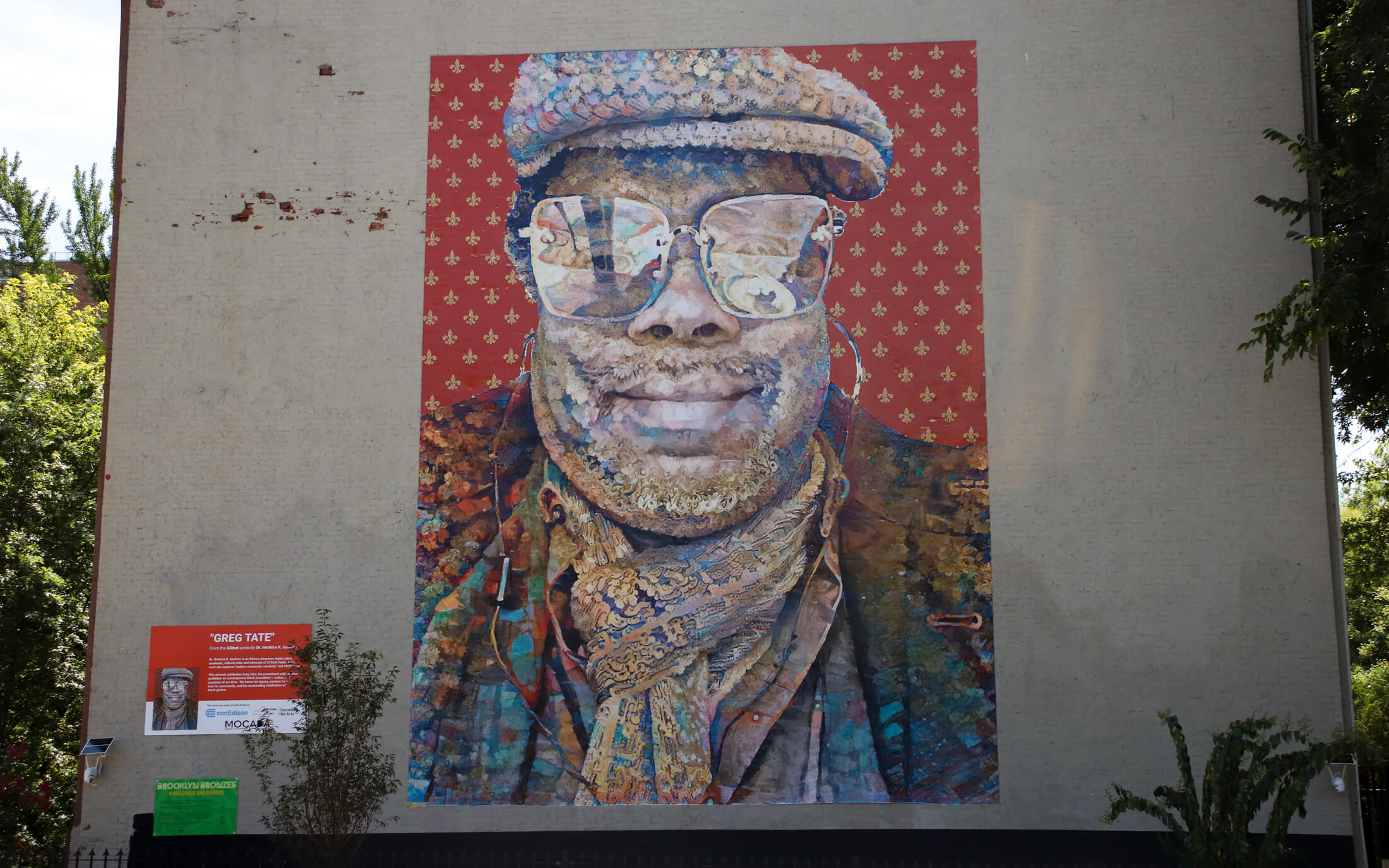 portrait of greg tate on the side of the adjoining building by 