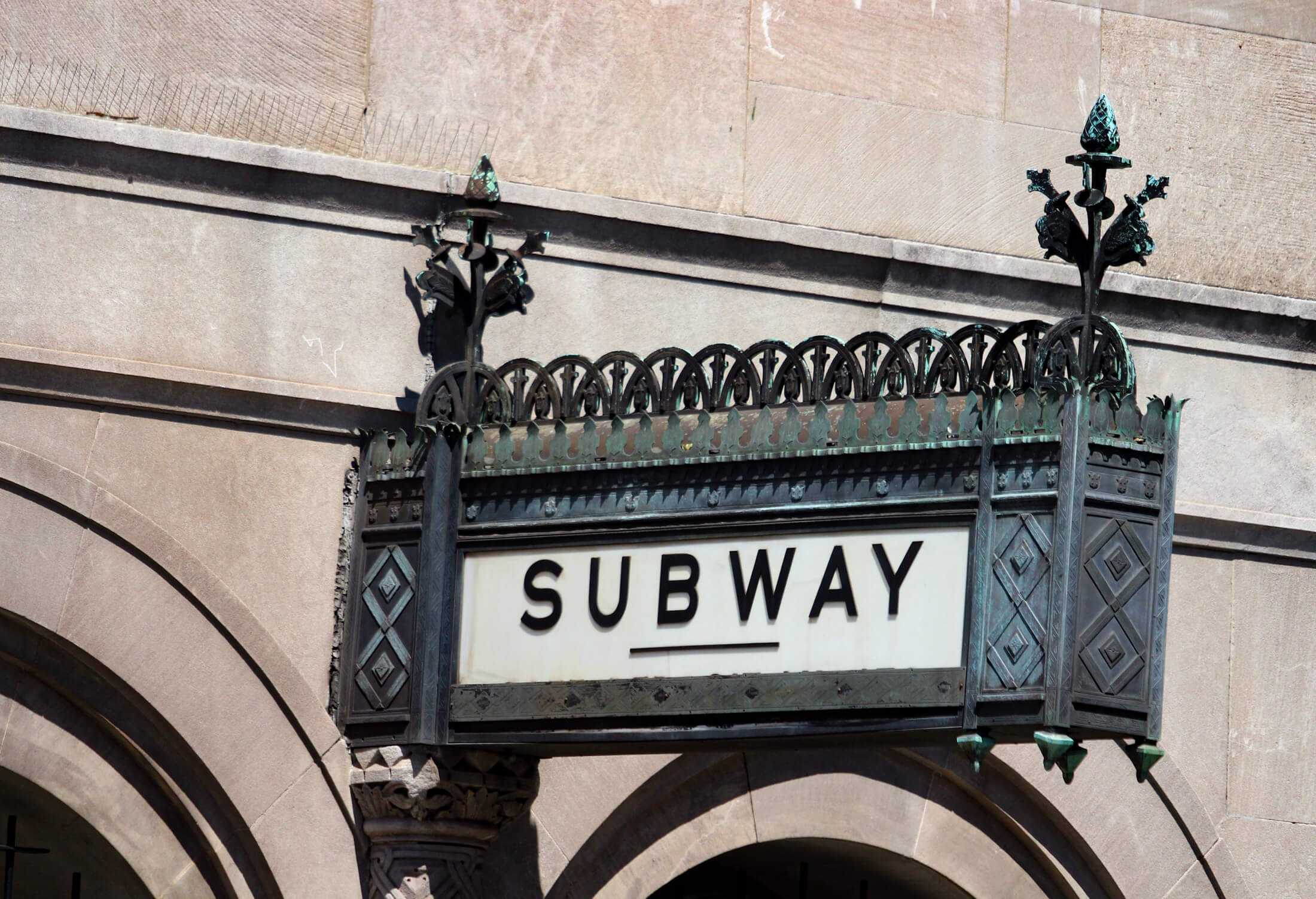 a sign for the subway mounted on the williamsburgh savings bank tower