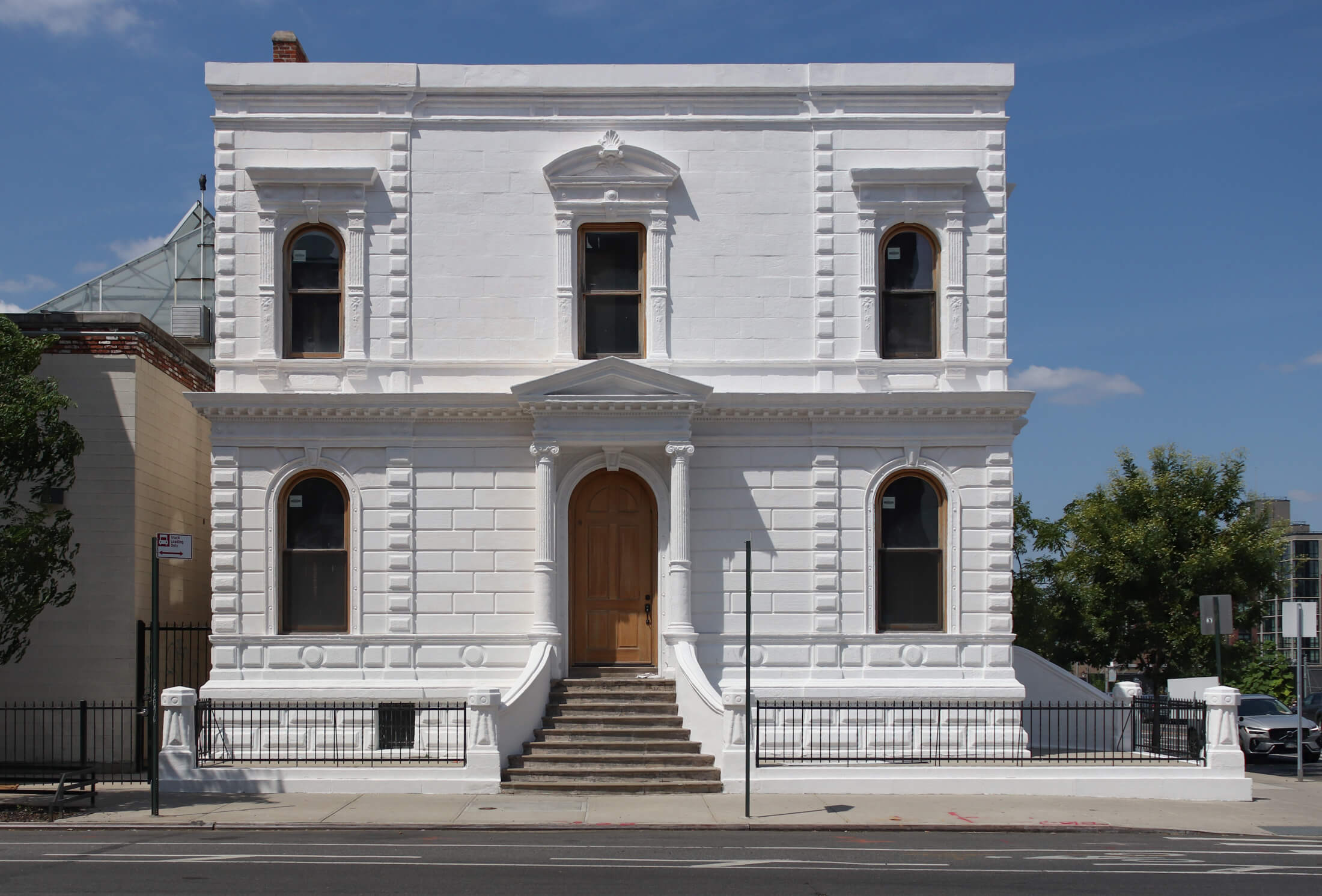 the 3rd avenue facade of the stone building with bright white paint