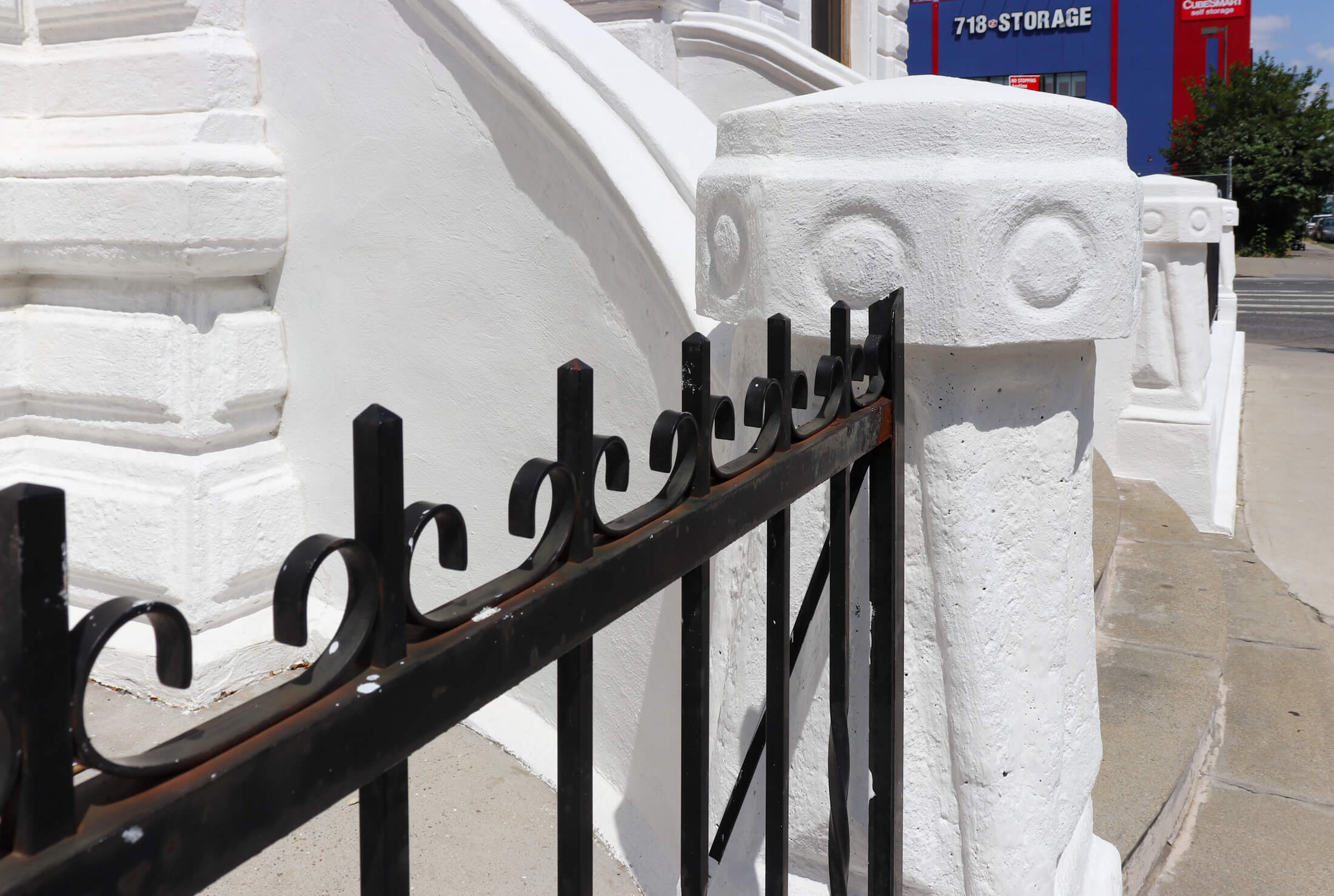 splatters of white paint on an iron railing