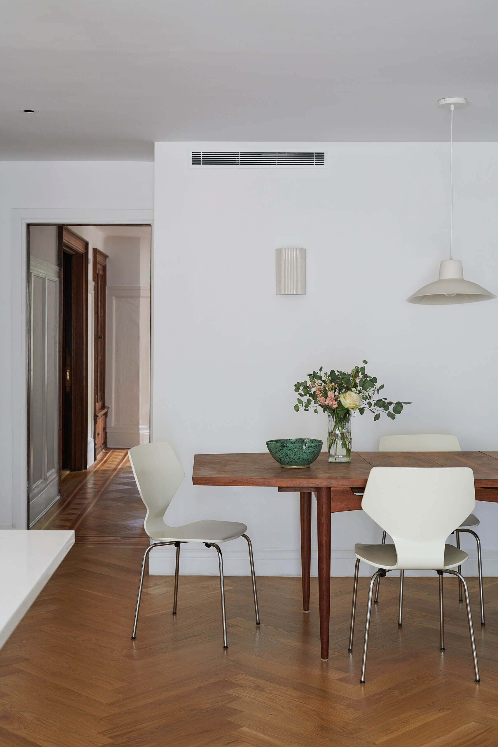 DINING ROOM with white chairs and a wood table