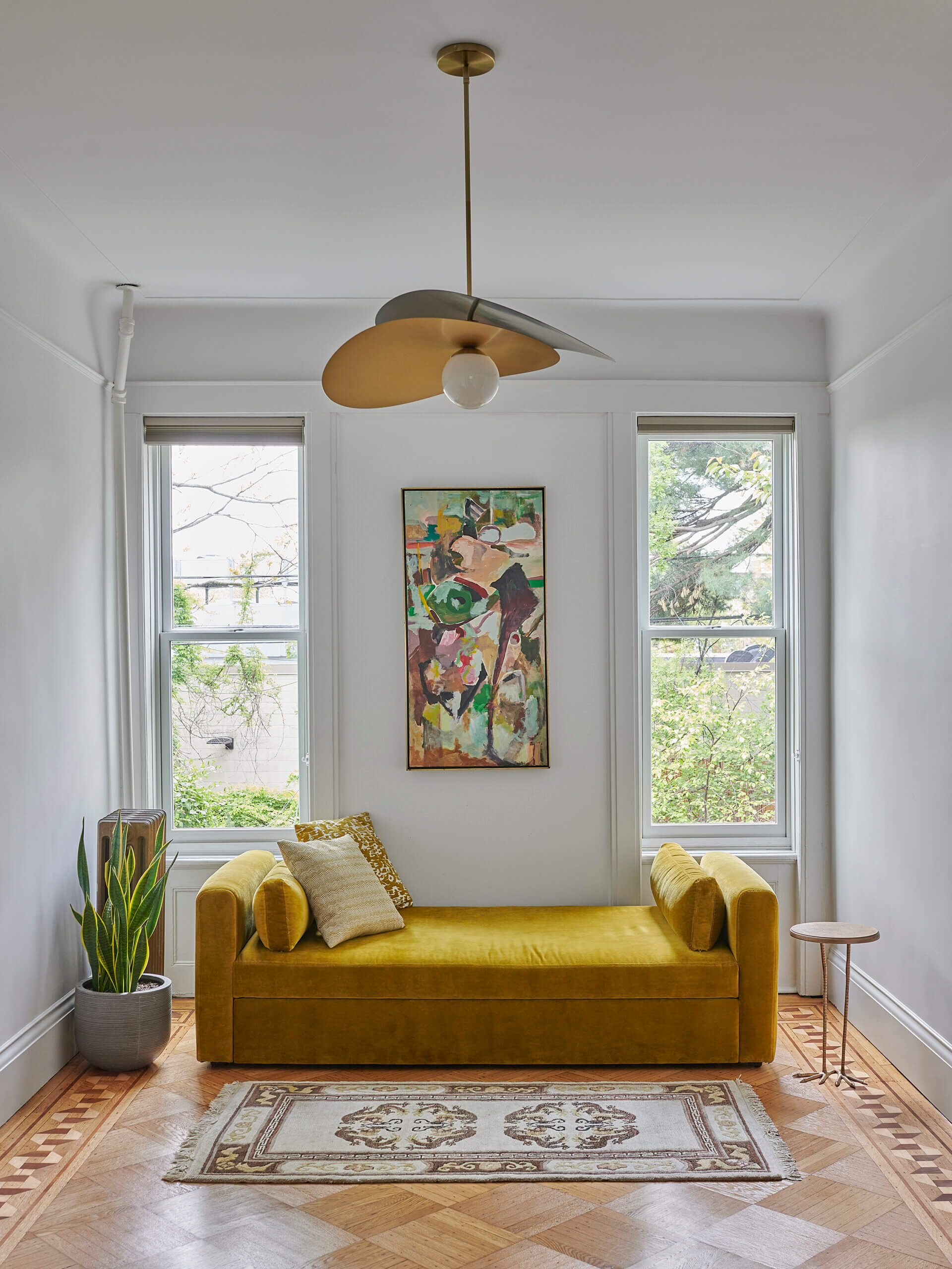 GUEST BEDROOM with a modern light fixture and two windows