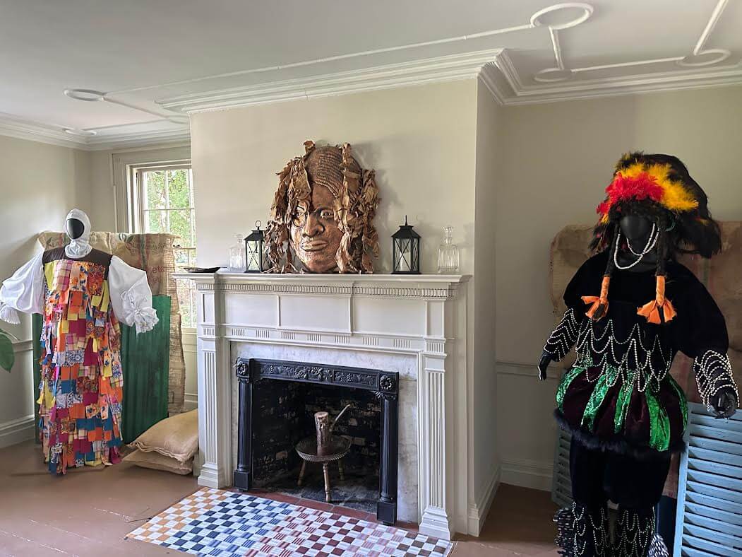costumes on either side of a historic mantel