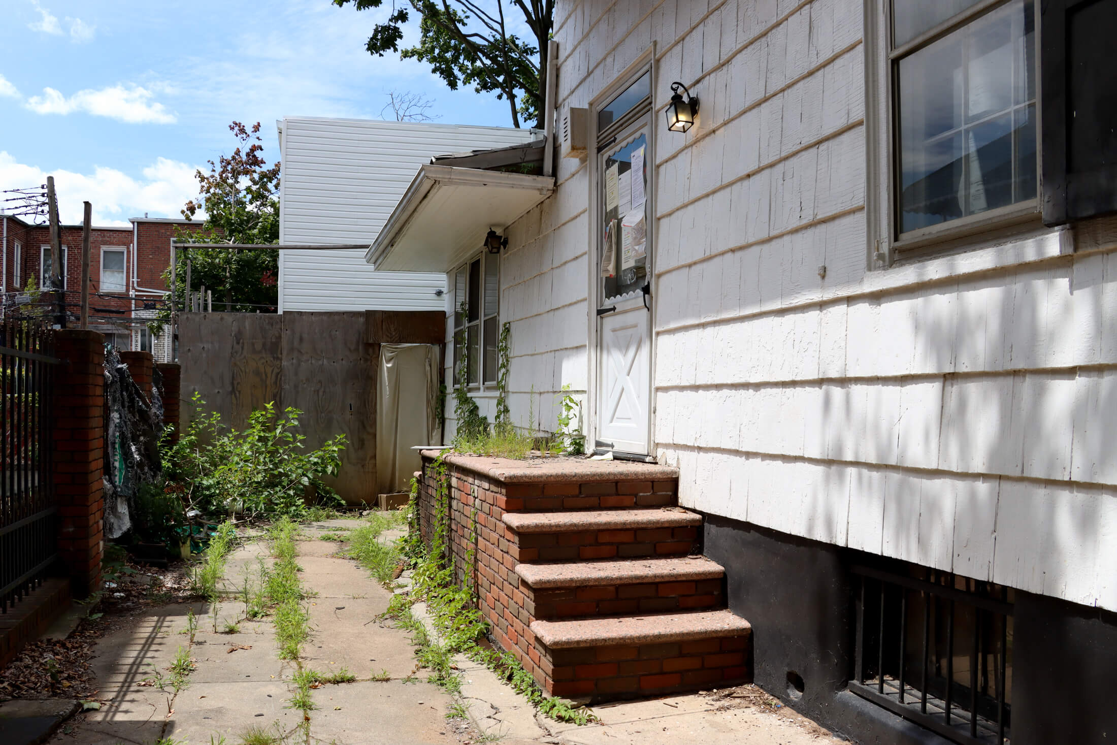 view of driveway with glimpse of construction behind