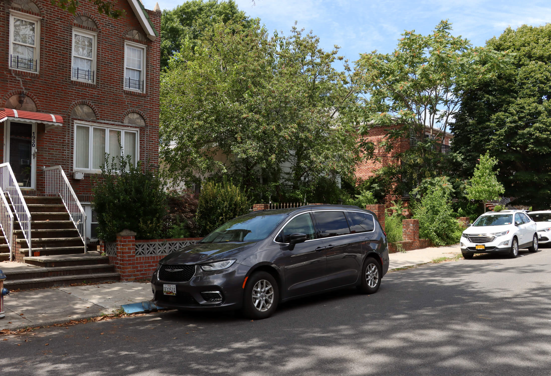 streetview showing 1920s brick houses surrounding the wood frame house