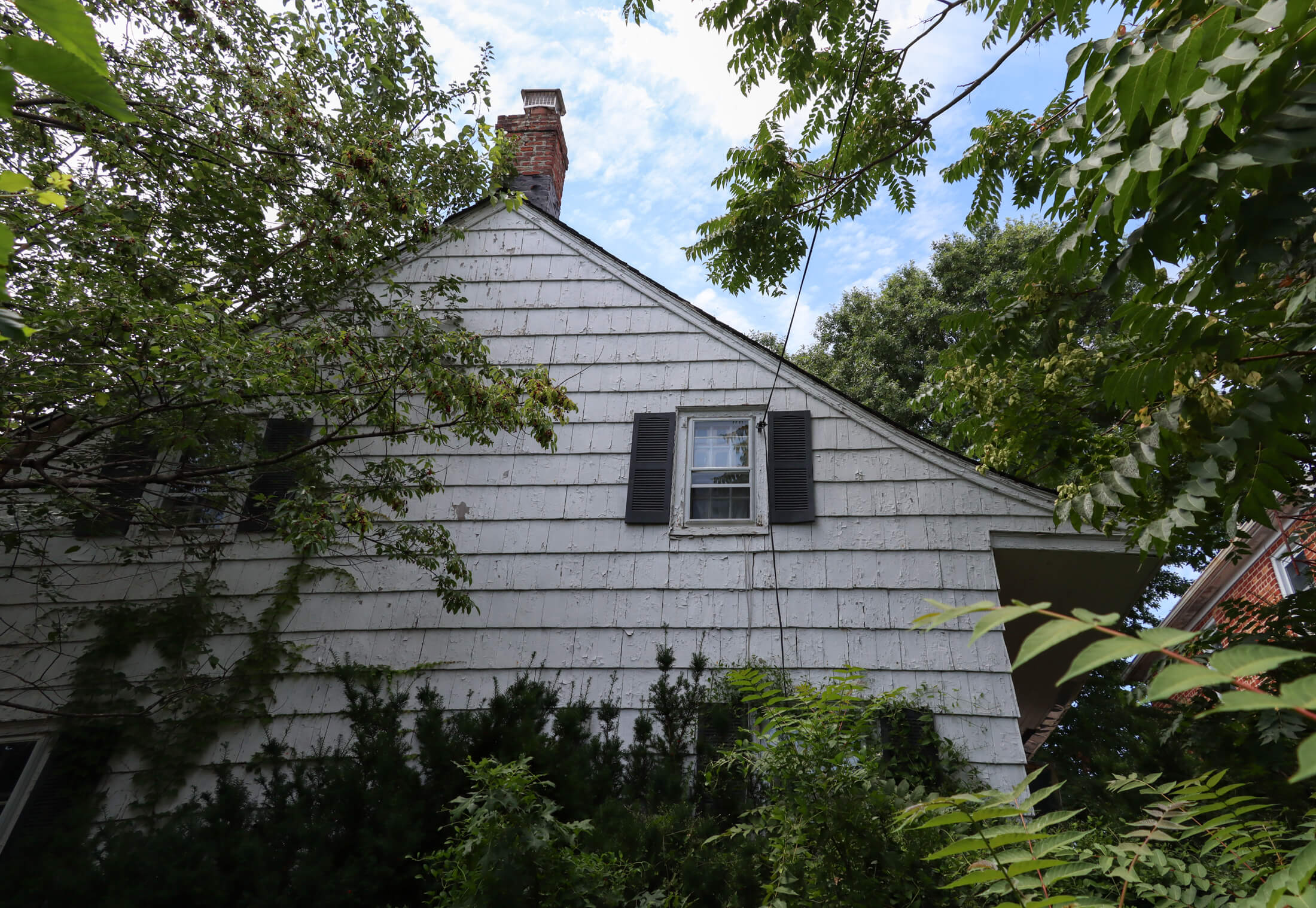 ryder house - wood frame house with overgrown lawn