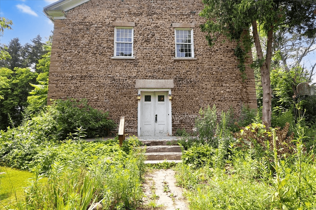 view of front facade with central door and two windows